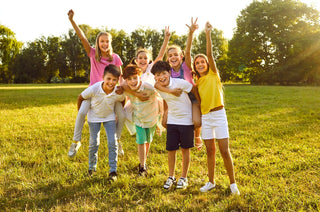 Group of school kids on a field on a sunny day